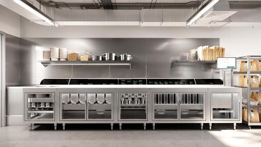 A modern kitchen with stainless steel cabinets and shelves featuring a Chipotle robot.