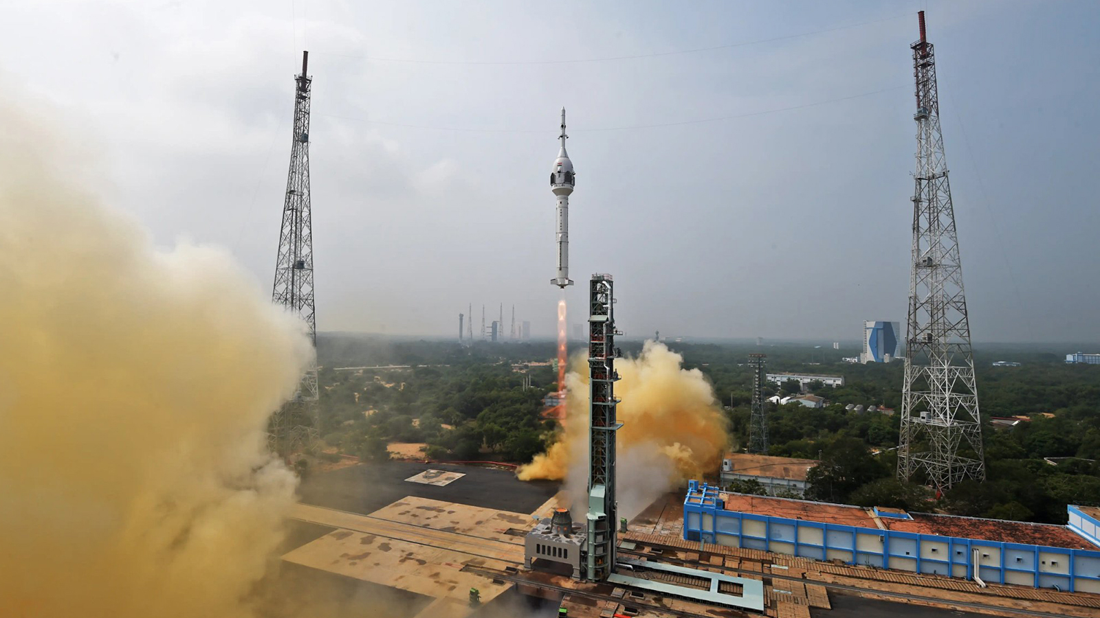 A rocket is being launched with smoke coming out of it.