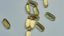 A group of omega 3 capsules on a white surface.