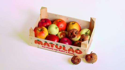 A wooden box with apples in it.