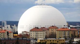 A large white dome in the middle of a city.