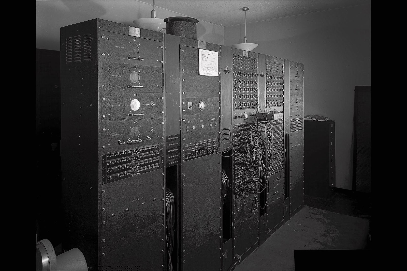 A black and white photo of a large analog computer
