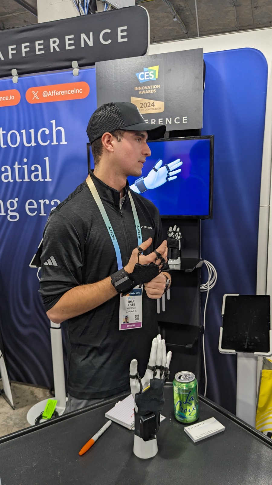 A man wearing a black hat and lanyard.