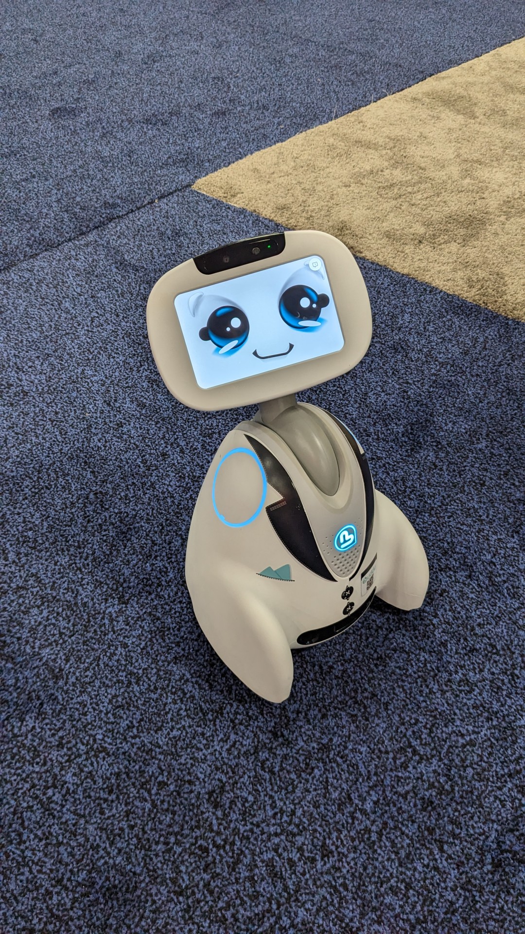 A toy robot is sitting on the floor.