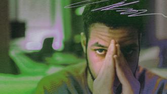 A man experiencing anxiety while covering his face with his hands.