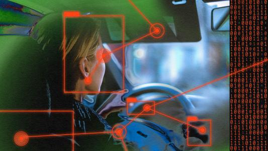 An image of a woman driving a car with car cameras.