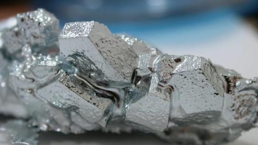 A close up of a piece of silver metal.