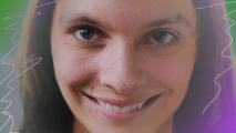 A still of Caitlin Stasey smiling from the horror movie, 'SMILE.'
