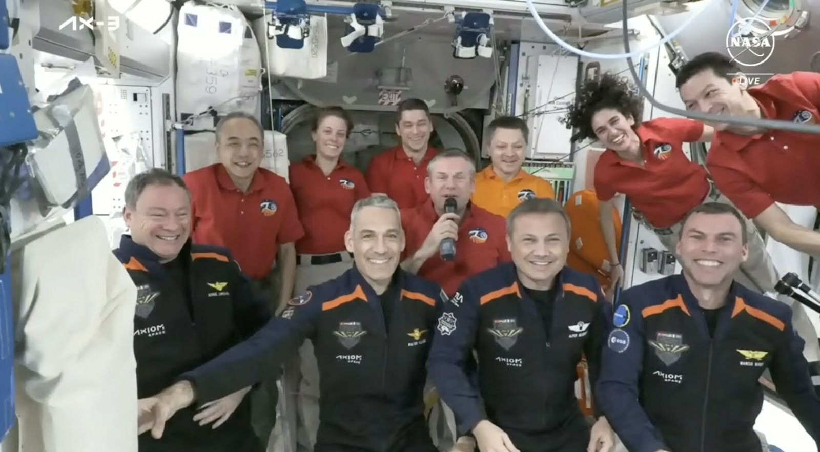 A group of people posing in the international space station.