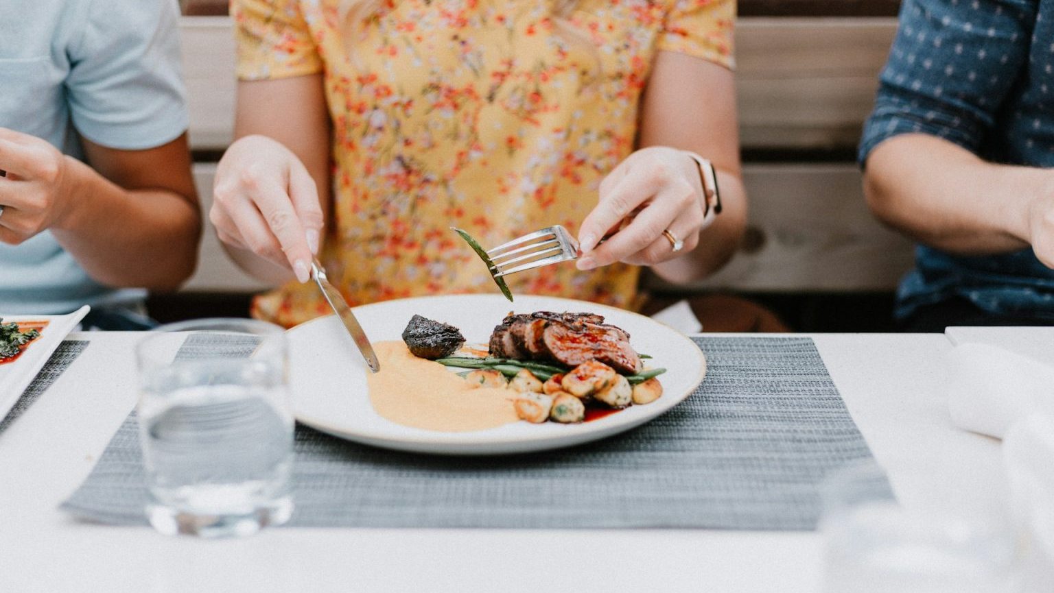 A group of people eating food at a restaurant.