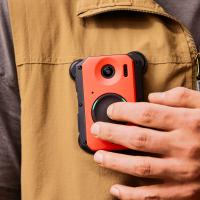 A man holding a cell phone in his pocket.