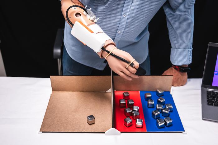 A man using a robotic arm to open a box.
