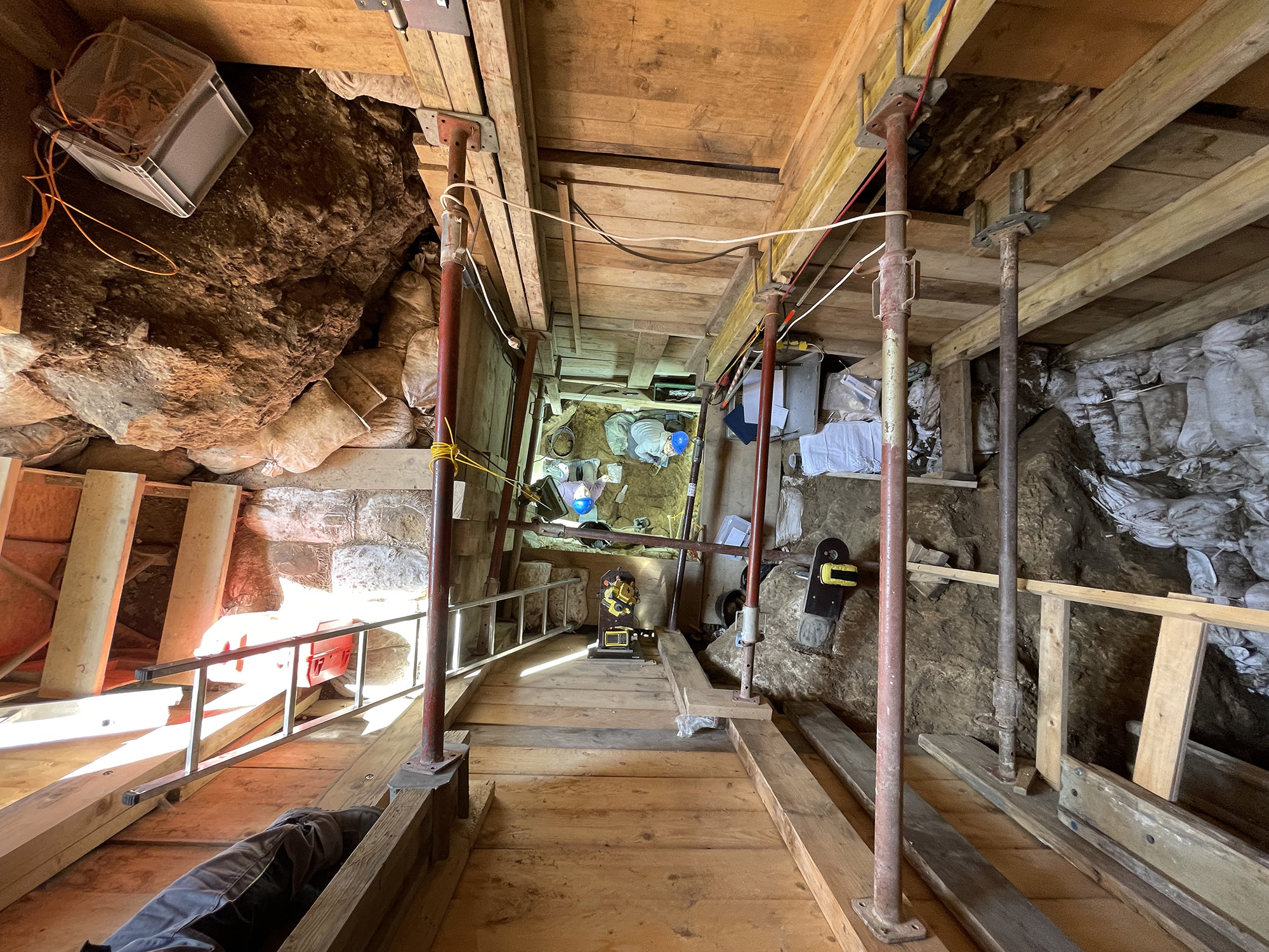 A top-down view of researchers working inside the re-excavated site in Ranis, Germany.