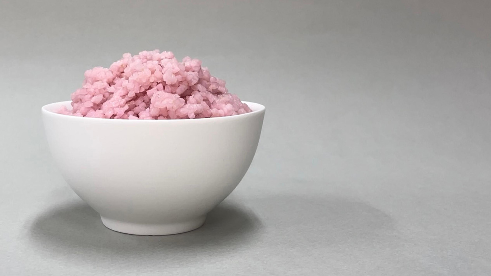 a white bowl full of pink rice