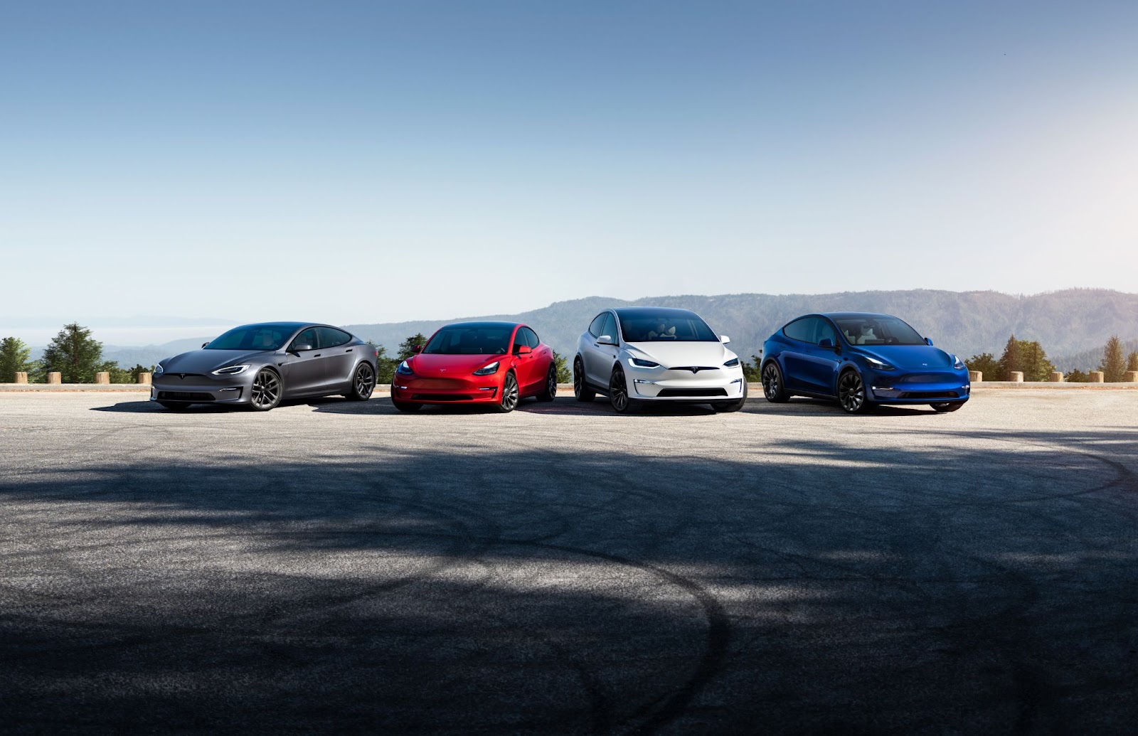 Four Teslas parked side by side