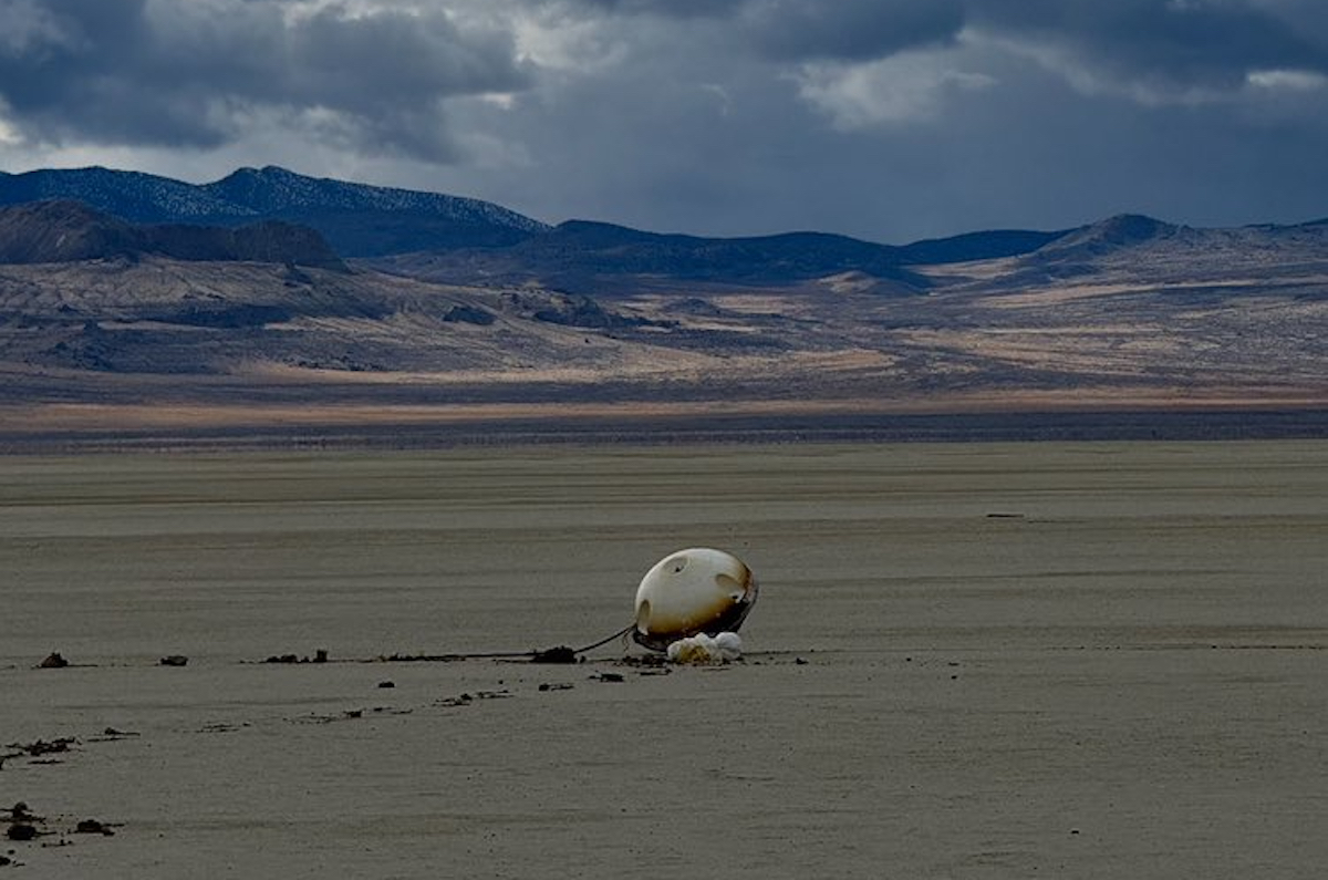 a capsule on the ground in the desert
