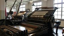 A large printing machine in a room.