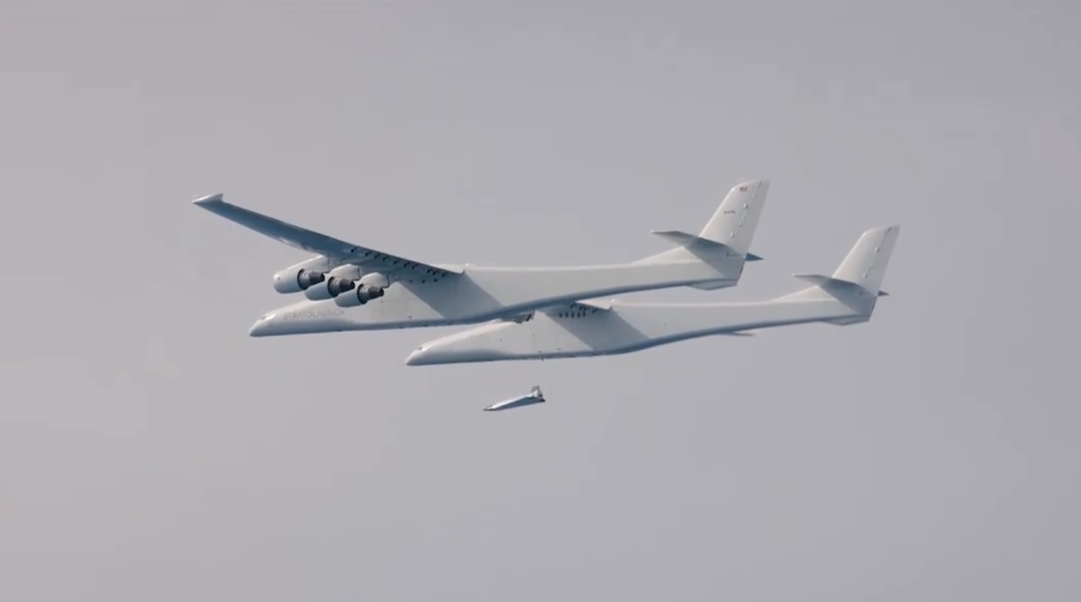 a massive plane dropping a smaller plane while in flight