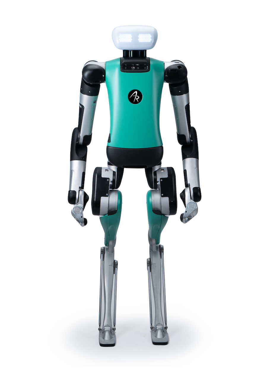 Agility Robotics' humanoid robot Digit. It is mostly team and black, and has a white, rectangular head with large lights for eyes