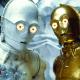 Close-up of C-3PO, a golden humanoid robot from Star Wars, standing next to version that is bluish white