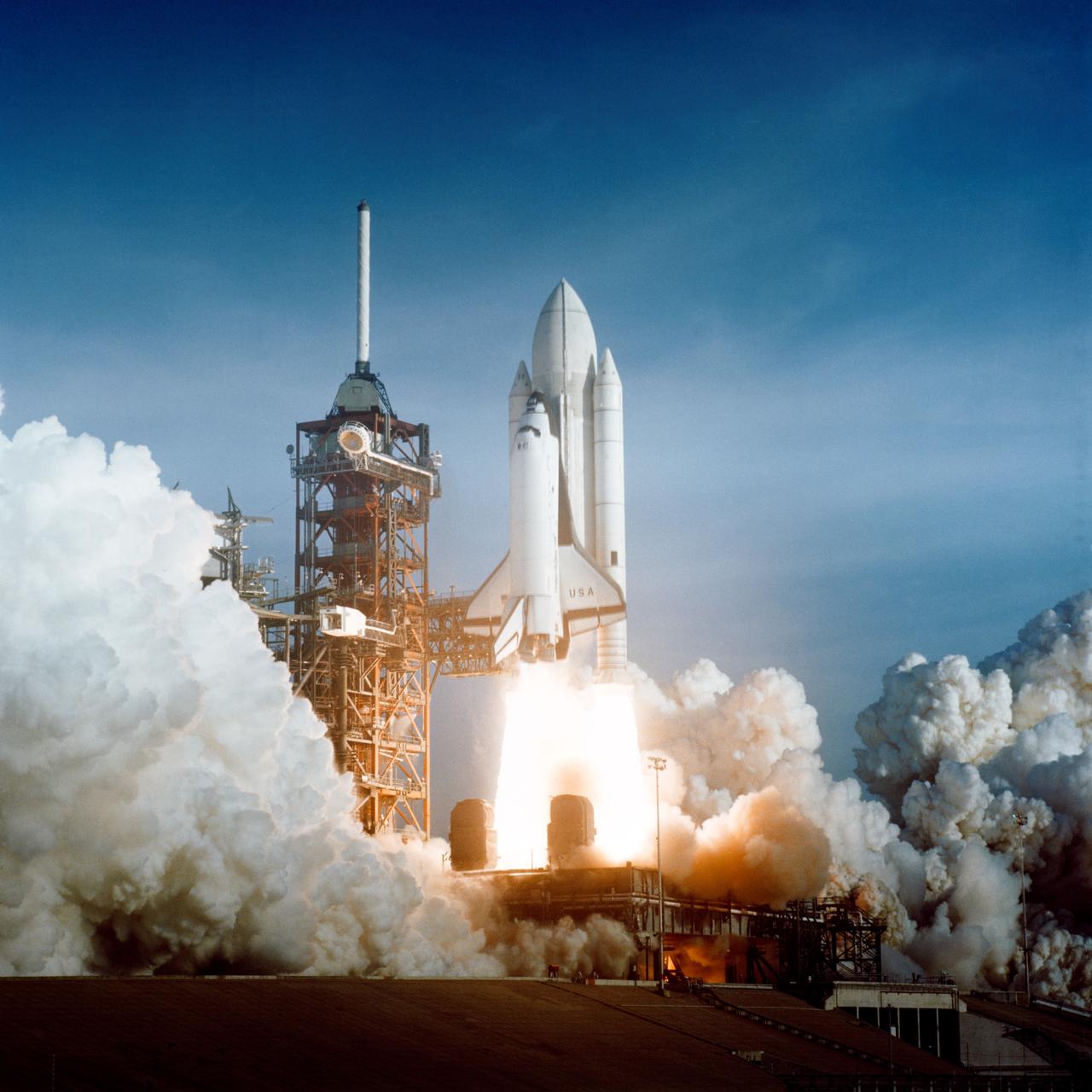 A space shuttle attached to a rocket lifting off