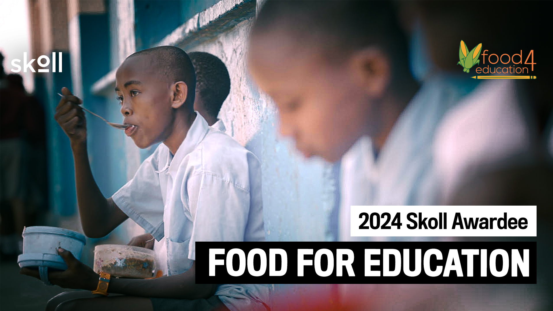 Three children are eating from bowls while seated against a wall. Text on the image reads: "2024 Skoll Awardee: Food for Education.