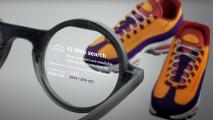 A magnifying glass highlighting shoe prices on a digital display, with a pair of colorful sneakers blurred in the background.