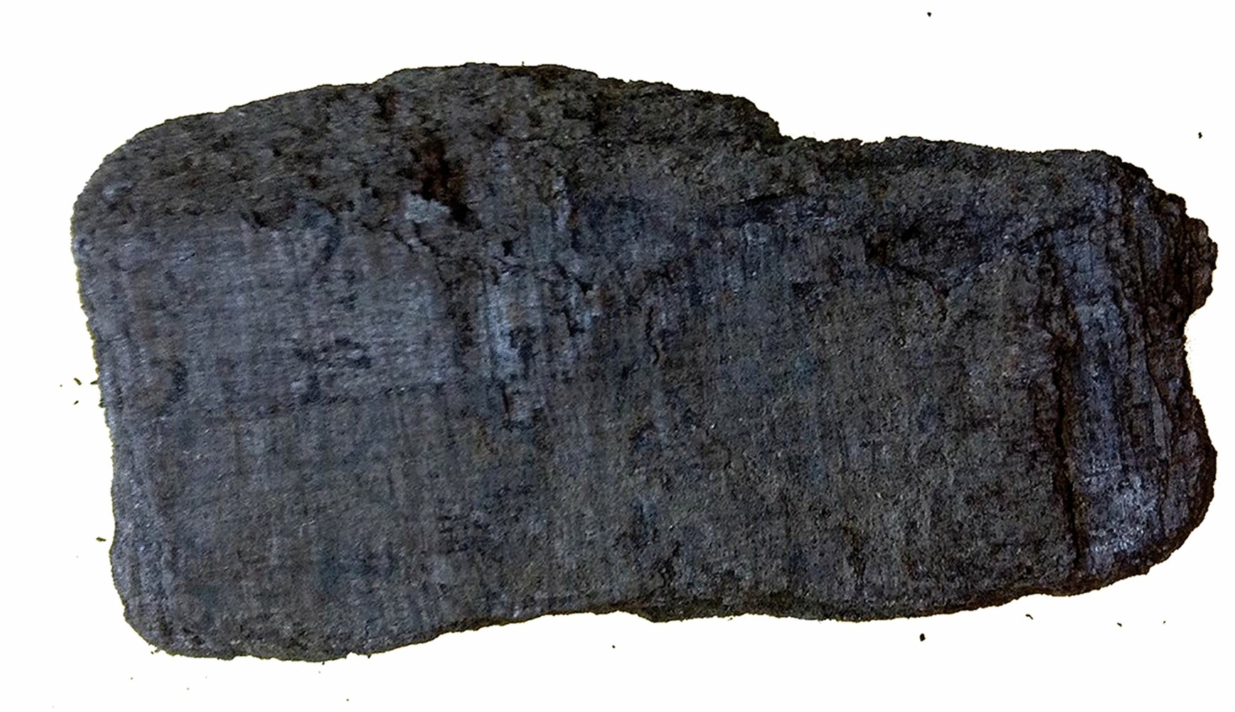 a paper scroll that has been charred black on a white background