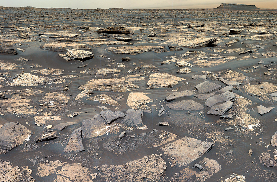 An image of Mars’ Gale Crater taken by the Curiosity rover. It is rocky and desolate. 