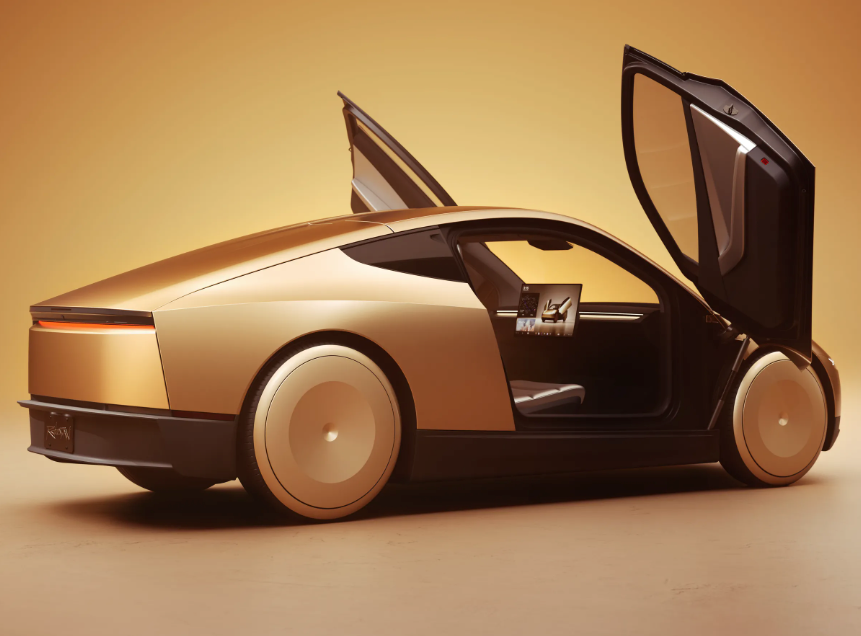 A sleek, gold modern electric car with gull-wing doors open, displayed in a studio with a warm amber background.