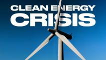 Wind turbine against a clear blue sky with bold white text reading "Clean Energy Crisis" in the background.