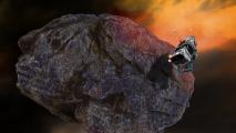 A spacecraft flying near the surface of a large, rocky asteroid in space, with a fiery sky in the background