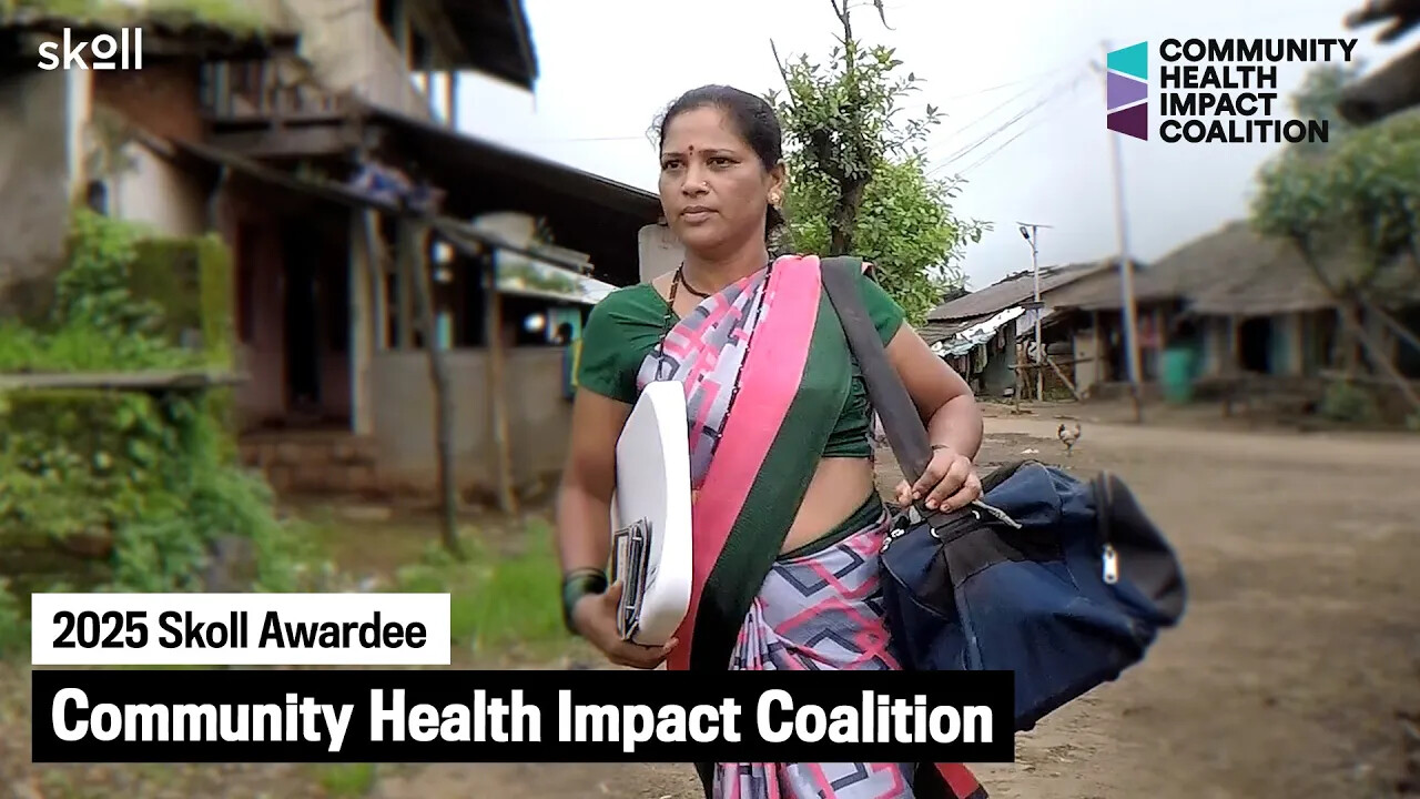 A woman in a saree carries a large bag and folder, walking outside in a rural area. Text reads "2025 Skoll Awardee Community Health Impact Coalition." Logos are in the corners.