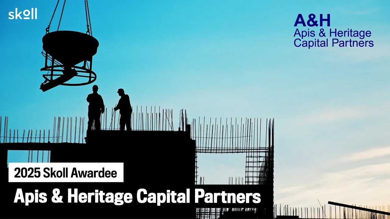 Two construction workers stand on a building framework at sunset; text reads "2025 Skoll Awardee: Apis & Heritage Capital Partners" with the A&H logo in the top right corner.
