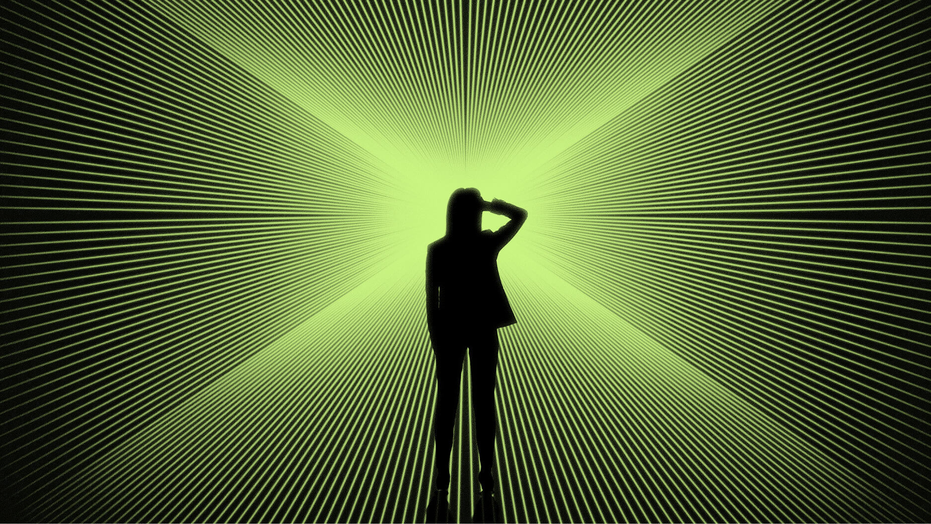 Silhouette of a person standing in front of a bright green, radial light pattern creating an optical illusion effect.